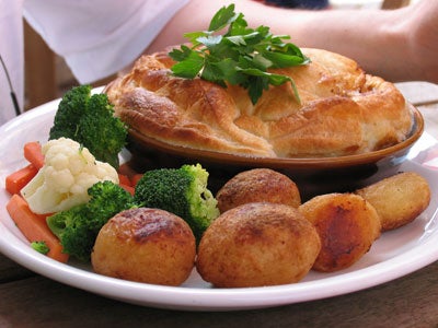 Close-up photo of a person's eye taken with the Canon PowerShot Pro1 showcasing the camera's detailed imaging capability.Plate of food featuring a pie garnished with parsley, surrounded by vegetables including broccoli, cauliflower, carrots, and roasted potatoes, possibly taken to demonstrate the image quality of the Canon PowerShot Pro1 camera.
