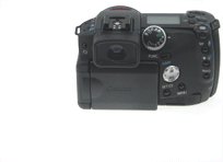 Rear view of Canon PowerShot Pro1 digital camera on a light background showing controls and screen.