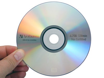 Hand holding a Verbatim DVD+R disc with reflective rainbow patterns, compatible with NEC ND-3500A DVD Writer, indicating 4.7GB capacity and 16x speed certification.
