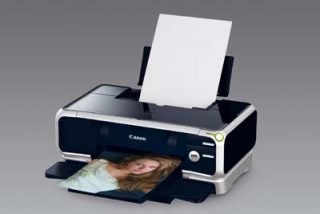 Canon Pixma iP5000 inkjet printer with a printed photo emerging from the output tray.