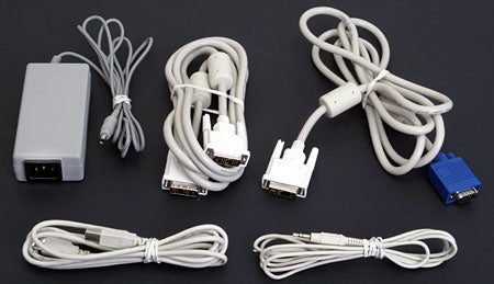 Various cables and an adapter for the Sharp LL-151-3D 3D LCD Monitor, including power and video connectors, laid out on a dark background.