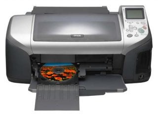 Epson Stylus Photo 300 inkjet printer with an open paper output tray displaying a printed CD with a floral design.