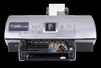 HP Photosmart 8450 inkjet printer with open paper output tray and on-screen photo preview.