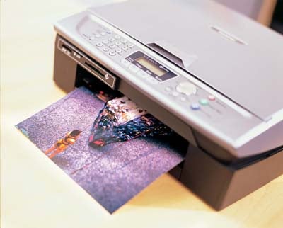 Printed photo ejecting from the Brother MFC-410CN multifunction printer showcasing print quality.
