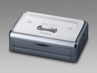Canon Selphy CP500 Compact Photo Printer on a neutral background, showcasing its sleek silver and gray design with brand logo visible on top.