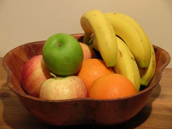 A colorful fruit bowl containing green and red apples, oranges, and a bunch of bananas, likely to demonstrate the image quality of the Nikon CoolPix 4800 camera.