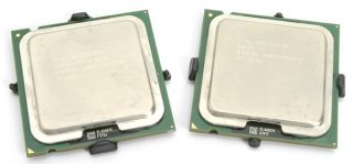 Two Intel Pentium 4 processors displaying model information on the metallic heat spreader, resting on a nondescript surface. The processor on the left is labeled with model 660/3.60GHz/2M/800, and the one on the right is the Extreme Edition 3.73GHz, both indicating 64-bit support.