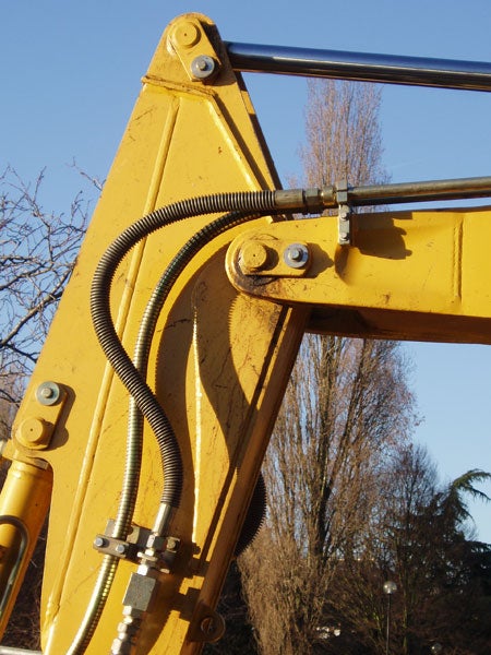Close-up photo of the arm of a yellow excavator with clear blue sky in the background, demonstrating the image quality of the Olympus µ (Mju) Digital 500 camera.