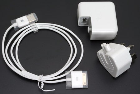 Apple iPod Photo accessories including a USB cable, a dock connector, and power adapters.