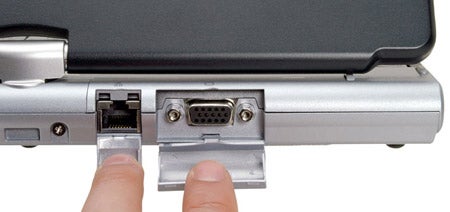 Close-up view of the connectivity ports on a Fujitsu-Siemens Lifebook T4010 with a hand demonstrating the port covers.