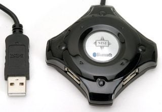 Close-up of the MSI Star Hub, a star-shaped black USB and Bluetooth hub with an MSI logo in the center, showing one connected USB cable with a white background.