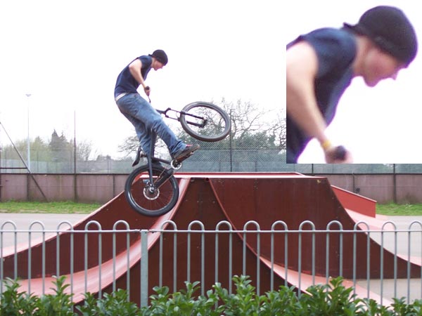 A person performing a bike stunt at a skate park, with the focus on the person doing the jump while the inset shows a cropped, out-of-focus action shot, demonstrating the capabilities of the Kodak EasyShare Z700 camera.