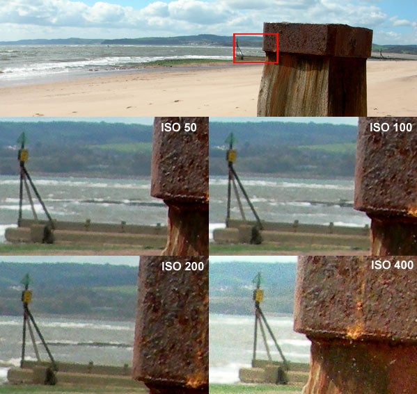 Comparison of photo quality taken with Nikon Coolpix 7900 digital camera at different ISO settings, showing a beach scene and close-ups of a metal post at ISO 50, 100, 200, and 400 with increasing noise levels.