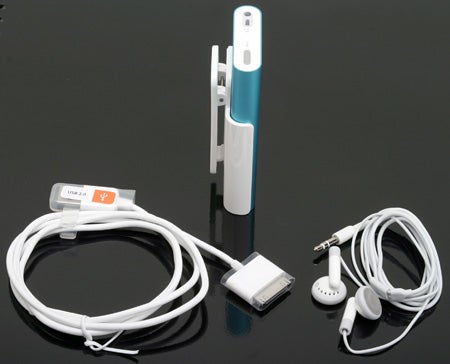 iPod mini - 2nd Gen 6GB with accessories including white earbuds, USB cable, and clip displayed on a reflective surface.