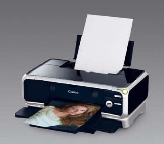 Canon Pixma iP8500 photo printer with a printed photograph emerging from the output tray.