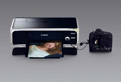 Canon Pixma iP8500 photo printer connected to a DSLR camera, with a printed photo coming out of the printer.