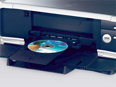 Close-up of a Canon Pixma iP 8500 photo printer with a CD/DVD printing tray extended showing a printed disc.