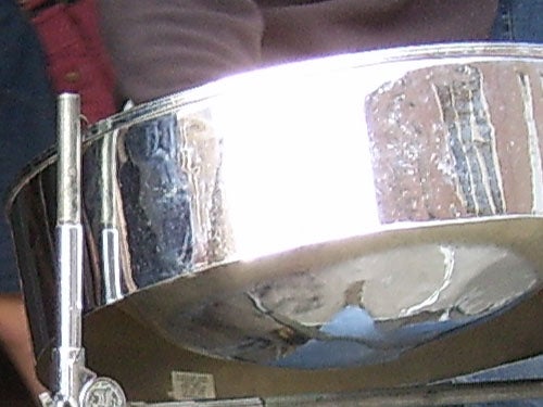 Close-up of a reflective snare drum surface.