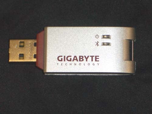 Gigabyte USB dongle with Bluetooth and Wi-Fi capabilities, featuring the Gigabyte Technology logo on a metallic surface.