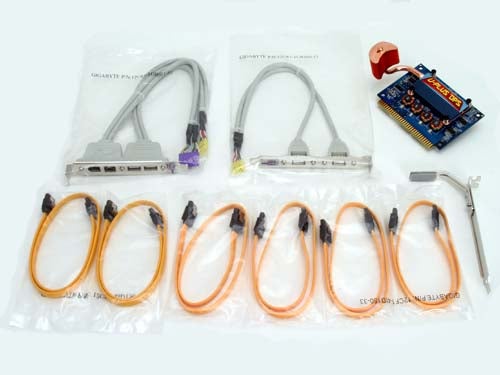 Accessories included with the Gigabyte GA-8N-SLi Royal motherboard, featuring cables, a backplate, and other components on a white background.
