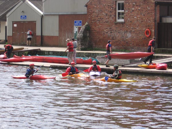 A group of kayakers paddling on a river captured with the Canon PowerShot A510 digital camera.