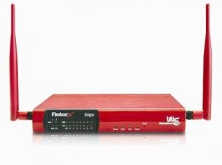 Red WatchGuard Firebox X15w wireless router with two antennas on a white background.
