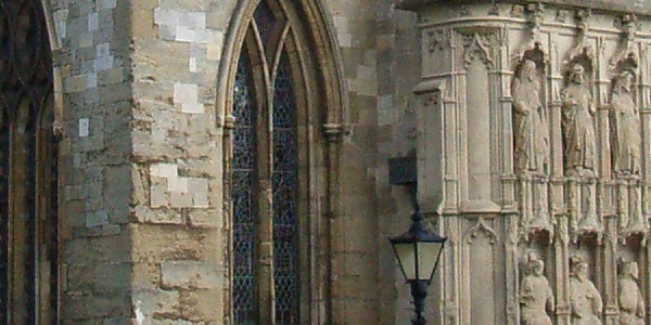 Image taken with a Ricoh Caplio R1V digital camera showing the detailed architecture of a historical building with a stone facade, arched windows, and intricate sculptures, demonstrating the camera's ability to capture sharp images.