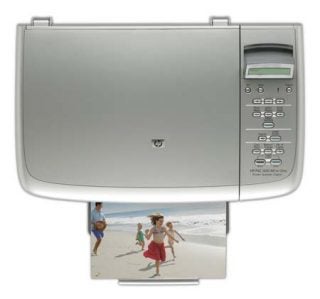 HP PSC 1610 Multi-Function Device showing the control panel and a printed photo of a family at the beach emerging from the printer's output tray.