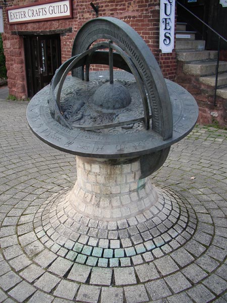 A photo captured with the Pentax Optio S5n camera depicting an intricately designed sundial sculpture at the Exeter Crafts Guild, demonstrating the camera's image clarity and color reproduction.