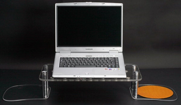 Laptop on a transparent EdgeBLUR surfACE stand with a black background