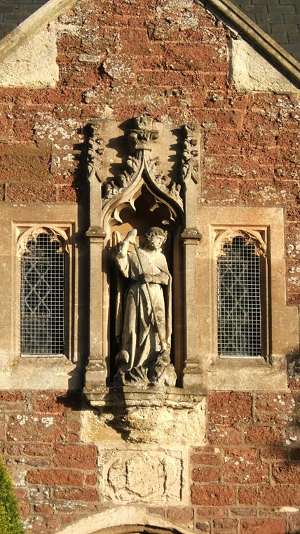 Statue of a figure in a niche with Gothic architectural elements on the exterior of a red brick building, captured in warm sunlight, demonstrating the image quality of the Fujifilm FinePix F810 Zoom camera.Close-up photograph of a stone sculpture and architectural details, possibly taken with a Fujifilm FinePix F810 Zoom camera demonstrating image quality and zoom capabilities.
