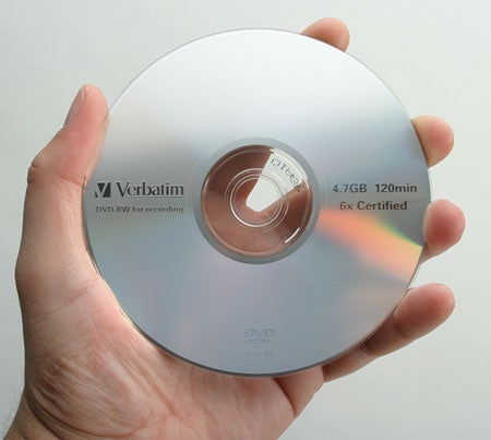 Hand holding a Verbatim DVD labeled 4.7GB 120min 6x Certified, possibly used for demonstration in a review of the NEC ND-3540A DVD Writer.