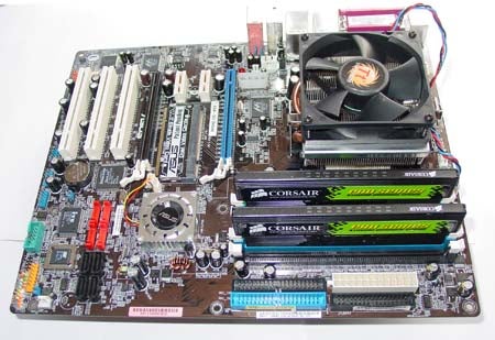 Motherboard with an AMD Athlon FX-57 processor and multiple Corsair memory modules installed, with a cooling fan over the CPU.
