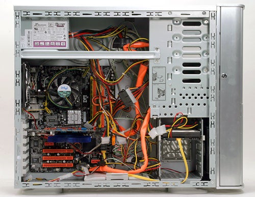 Interior view of SilverStone Temjin TJ05 computer case showing the motherboard, CPU cooler, various cables, and drive bays, demonstrating the internal layout and cable management features.