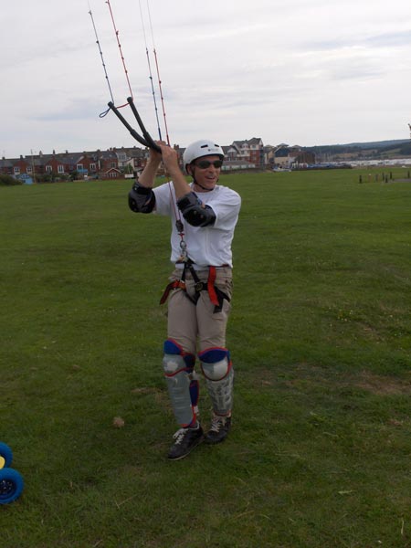 Person wearing sunglasses and a helmet while engaging in an outdoor activity, possibly paragliding, captured with the HP Photosmart M22 Digital Camera.A person kitesurfing on land while wearing protective gear and a helmet, possibly demonstrating image clarity and outdoor performance of the HP Photosmart M22 Digital Camera.