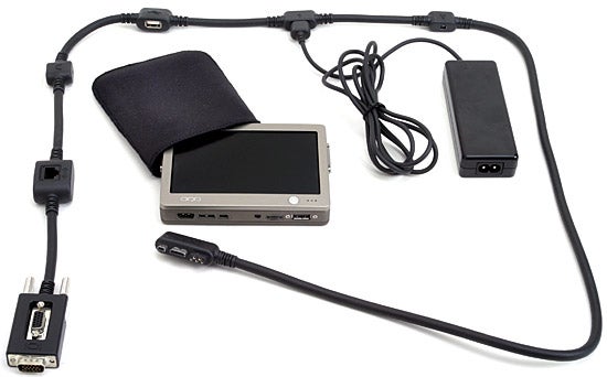 OQO model 01 pocket-sized PC displayed with its accessories including power adapter, cables, and a protective sleeve on a white background.