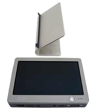 OQO model 01 Pocket Size PC with screen and keyboard closed, viewed from the front, alongside its removable battery standing upright behind it.