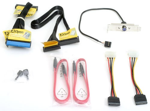 Assorted cables and accessories for the AOpen motherboard, including IDE cables, a USB bracket, and SATA cables on a white background.