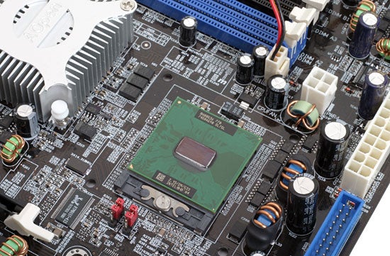 Close-up of AOpen i915GMm-HFS Pentium M motherboard showing CPU socket, RAM slots, and various capacitors and connectors.