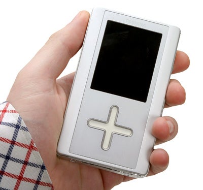 Hand holding Toshiba Gigabeat F20 Portable Audio Player with a prominent cross-shaped control pad and screen.