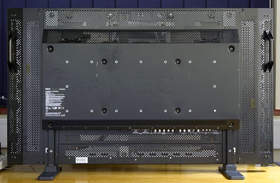 Rear view of the NEC MultiSync LCD4610 46-inch Public Display stand, showcasing the monitor's back panel with ventilation holes, support structures, and branding.