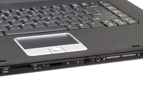Close-up of the Acer Ferrari 4000 Notebook's keyboard and touchpad area, highlighting the multimedia keys and ports on the side.
