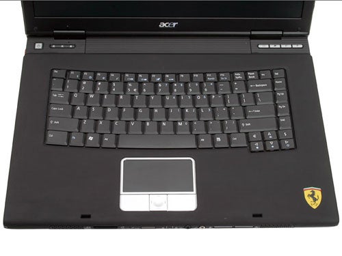 Close-up view of the Acer Ferrari 4000 Notebook's keyboard and touchpad showing the black color scheme and Ferrari logo.