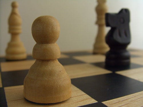 Close-up photo of a wooden chessboard with a focus on a pawn piece, illustrating the depth of field capability of the Casio EX-P505 camera.