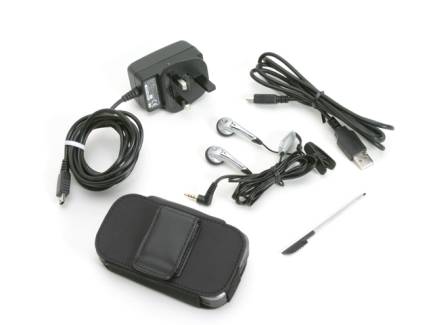 Accessories and components of the Orange SPV M500 Smartphone including a charger, cables, earphones, a carrying case, and a stylus on a white background.