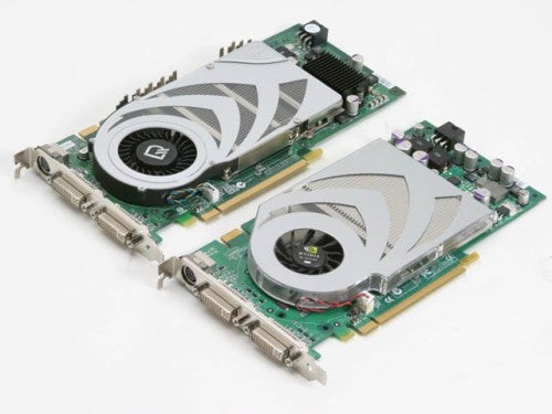 Two nVidia GeForce 7800 GT reference graphics cards lying side by side with white and gray cooling units.