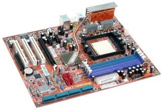 Overhead view of ABIT AN8 Ultra motherboard featuring passive cooling with a large copper heatsink, multiple blue RAM slots, and expansion slots on a red circuit board.