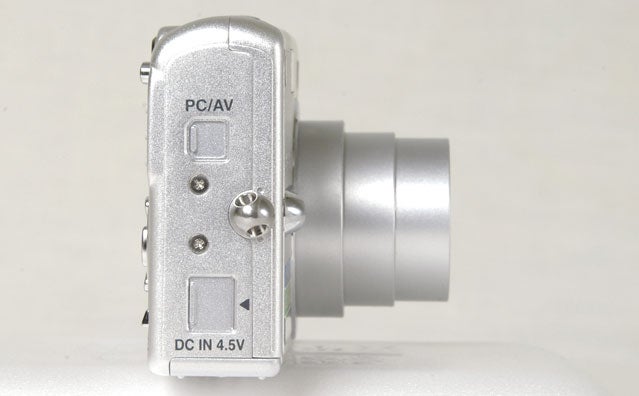 Side view of the Pentax Optio S5z digital camera showing the PC/AV ports and power input.