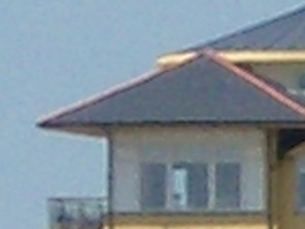 Close-up of a house roof captured with Pentax Optio S5z camera illustrating image quality and zoom capabilities.