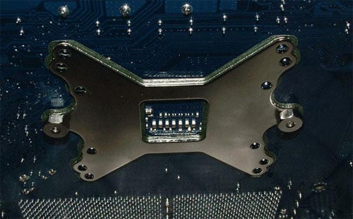 Close-up view of the mounting bracket for the Cooler Master Aquagate Mini R120 liquid cooling system on a computer motherboard.